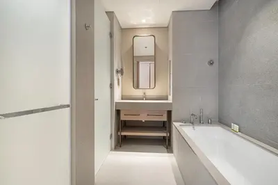 a bathroom with a tub and a sink and a mirror at Vida Dubai Mall! Excellent Amenities, Mall Connected! in Dubai