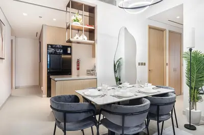 a kitchen and dining room with a table and chairs at Vida Dubai Mall! Excellent Amenities, Mall Connected! in Dubai