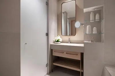 a bathroom with a sink and a mirror at Vida Dubai Mall! Excellent Amenities, Mall Connected! in Dubai