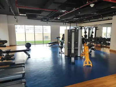 a gym with several treadmills and exercise bikes at Iconic Burj Khalifa View 2BR with Assistant Room, Steps from Dubai Mall and Beside a Park, Bellevue Towers 1, Downtown Dubai by Deluxe Holiday Homes in Dubai