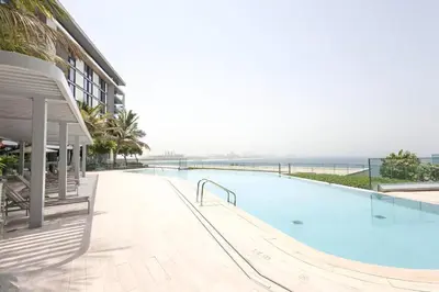 a swimming pool next to a building next to the ocean at TRPS - Bluewaters Residence 3, Bluewaters Island - Ain Dubai View, Fully Furnished, Close to JBR and Marina in Dubai