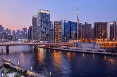 a city with a bridge over a river with buildings at Luxury 1BHK with Stunning Canal View Business Bay in Dubai