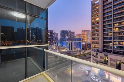 a view of a city skyline from an apartment balcony at Luxury 1BHK with Stunning Canal View Business Bay in Dubai
