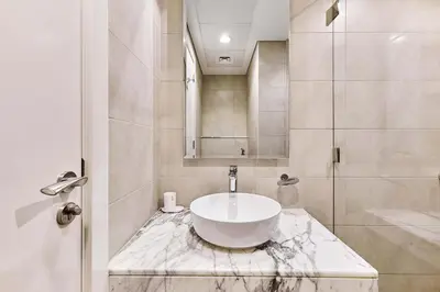 a bathroom with a sink and a shower at Elegant 2BR Apartment Heart of Business Bay High Floor in Dubai