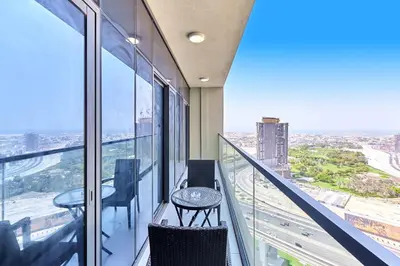 a balcony with two chairs and a table on a building at Elegant 2BR Apartment Heart of Business Bay High Floor in Dubai