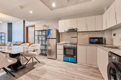 a kitchen with a table and a dining room at Millennium Heights 1 in Dubai