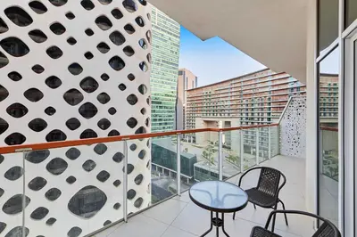 a balcony with two chairs and a table at Millennium Heights 1 in Dubai
