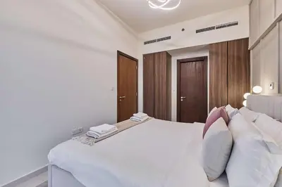 a bedroom with a large white bed with white pillows at Cityscape Comforts 2BR in Dubai