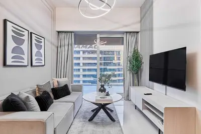a living room with a couch and a tv at Cityscape Comforts 2BR in Dubai