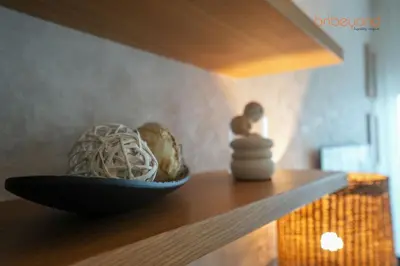 a shelf with a bowl of noodles and a stack of other items at Nomad Haven with Pvt Cinema and C0-working Space in Dubai