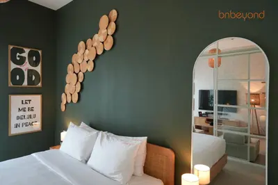 a bedroom with a white bed and a mirror at Nomad Haven with Pvt Cinema and C0-working Space in Dubai