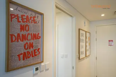 a poster on the wall of a room with no drawings on tricks at Nomad Haven with Pvt Cinema and C0-working Space in Dubai