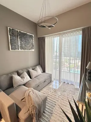 a living room with a couch and a large window at Cozy 1BR in Zada Tower Business Bay in Dubai