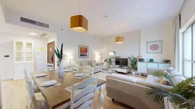 a living room with a table and a dining room at Vacationer I Luxury 2 Bedroom Apartment I Marina View I Steps from JBR Beach in Dubai