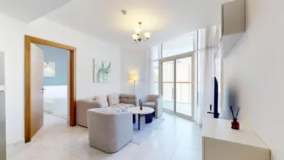 a living room with a couch and a tv at Vacationer l 1 Bedroom Perched on the 19th Floor l Free Pool, Gym Access in Dubai