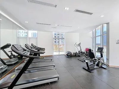 a gym with several treadmills and exercise bikes at Vacationer l 1 Bedroom Perched on the 19th Floor l Free Pool, Gym Access in Dubai
