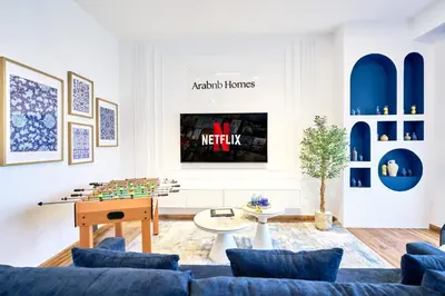 a living room with a blue couch and a table at Full Ocean & Palm Views Apartments in JBR Beachfront with Dubai Eye Views in Dubai