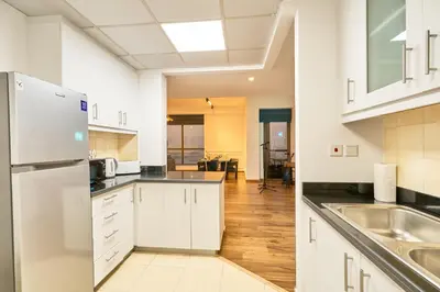 an empty kitchen with white cabinets and a sink at Full Ocean & Palm Views Apartments in JBR Beachfront with Dubai Eye Views in Dubai