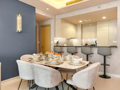 a dining room with a table and chairs at ElysianSky Burj Khalifa Views 3 Bedroom Apartment at Paramount Hotel Midtown with 64th Floor Rooftop Pool in Dubai