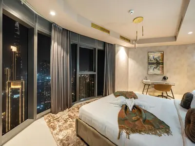 a bedroom with a bed with a view of the city at ElysianSky Burj Khalifa Views 3 Bedroom Apartment at Paramount Hotel Midtown with 64th Floor Rooftop Pool in Dubai