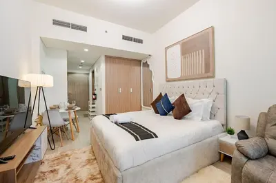 a bedroom with a large bed and a living room at Ramaira Homes Azizi Riviera 26 by Vacay Xeal in Dubai