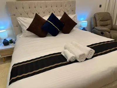 a bedroom with a bed with towels on it at Ramaira Homes Azizi Riviera 26 by Vacay Xeal in Dubai
