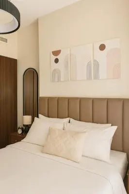 a bedroom with a large bed with white pillows at Modern 1BR Near Burj Khalifa Business Bay Reva Apt in Dubai