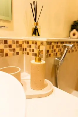 a bathroom counter with a soap dispenser next to a tub at Modern 1BR Near Burj Khalifa Business Bay Reva Apt in Dubai