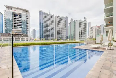 a swimming pool in the middle of a city with tall buildings at Modern 1BR Near Burj Khalifa Business Bay Reva Apt in Dubai