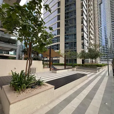 a courtyard in a city with tall buildings at Bellevue Towers Luxurious Burj Khalifa, Full Downtown & Old-town Views in Dubai