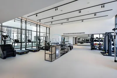 a gym with several treadmills and machines at Studio Near Ras Al Khor Wildlife Sanctuary with Partial Creek Views, Just Minutes from Downtown Attractions, Wilton Park Residences, Sobha Hartland by Deluxe Holiday Homes in Dubai