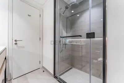 a shower with glass doors in a bathroom at Studio Near Ras Al Khor Wildlife Sanctuary with Partial Creek Views, Just Minutes from Downtown Attractions, Wilton Park Residences, Sobha Hartland by Deluxe Holiday Homes in Dubai