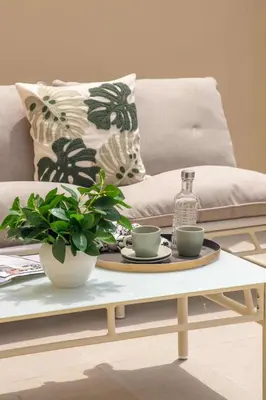 a coffee table with two cups and a bottle on it at Frank Porter - La Sirene, Jumeirah in Dubai