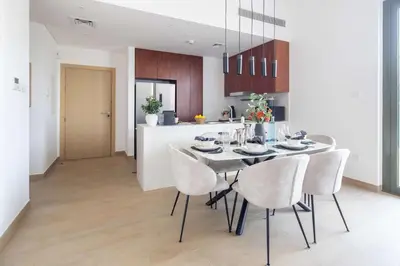 a kitchen and dining room with a table and chairs at Frank Porter - La Sirene, Jumeirah in Dubai