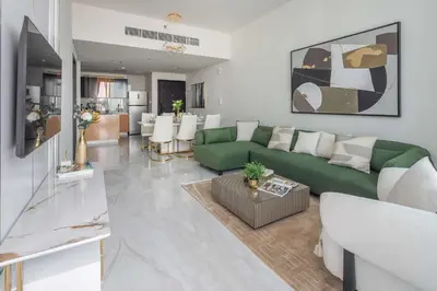 a living room with a green couch and a table at Frank Porter - GEMZ by Danube, Al Furjan in Dubai