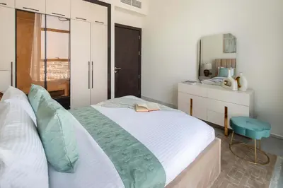 a bedroom with a large bed and a mirror at Frank Porter - GEMZ by Danube, Al Furjan in Dubai