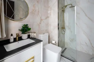 a bathroom with a toilet and a sink and a shower at Frank Porter - GEMZ by Danube, Al Furjan in Dubai