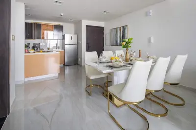 a kitchen and dining room with a table and chairs at Frank Porter - GEMZ by Danube, Al Furjan in Dubai