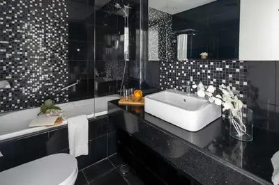 a bathroom with a sink and a tub and a toilet at Frank Porter - The Vogue, Business Bay in Dubai