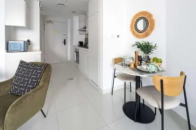 a kitchen and dining room with a table and chairs at Frank Porter - The Vogue, Business Bay in Dubai