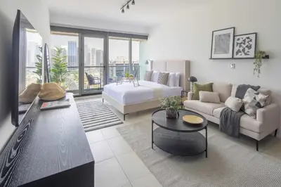 a living room with a bed and a couch at Frank Porter - Dubai Arch Tower , JLT in Dubai