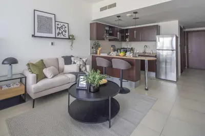 a living room and kitchen with a couch and a table at Frank Porter - Dubai Arch Tower , JLT in Dubai