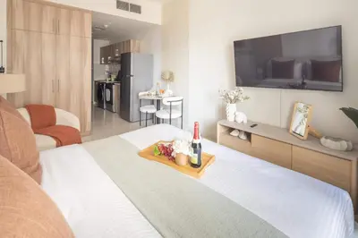 a room with a bed with a tray of food on it at Frank Porter - Hera Tower in Dubai