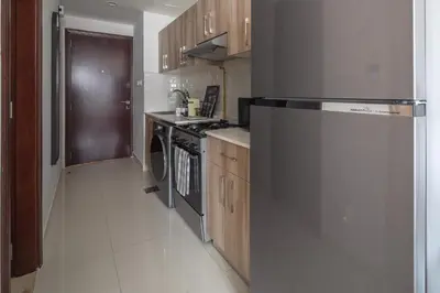 a kitchen with a stainless steel refrigerator and a dishwasher at Frank Porter - Hera Tower in Dubai