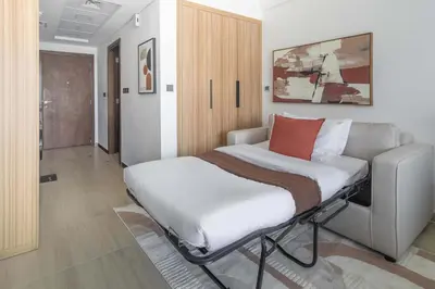 a hospital bed sitting in a room with at Frank Porter - Elysee III by Pantheon, JVC in Dubai