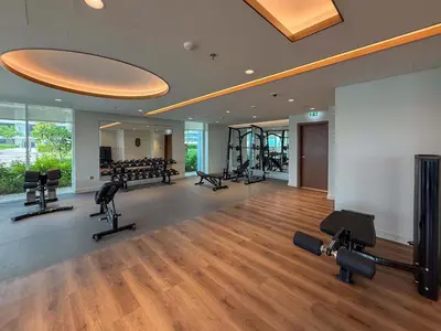 a gym with treadmills and cardio equipment in a building at Frank Porter - Palace Beach Residence Tower 2 in Dubai