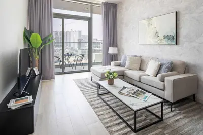 a living room with a couch and a table at Frank Porter - Bloom Heights Tower B in Dubai