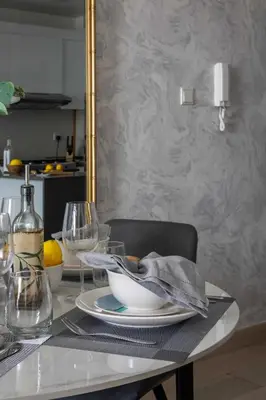 a dining room table with a plate and wine glass at Frank Porter - Bloom Heights Tower B in Dubai