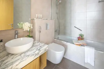 a bathroom with a sink and a toilet and a tub at Frank Porter - Aykon City Tower C in Dubai
