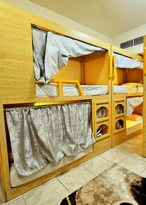 two bunk beds in a small room with a rug at PHOENIXWAVES VACATIONAL HOMEs in Dubai